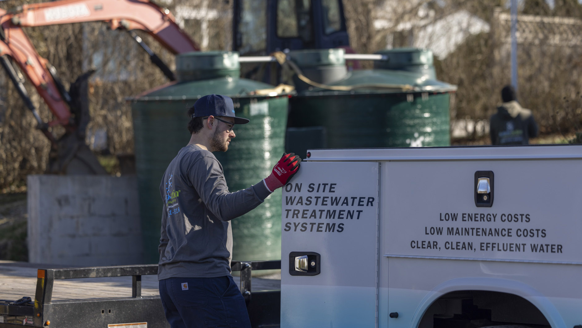 Wastewater Works installation truck beside treatment tanks
