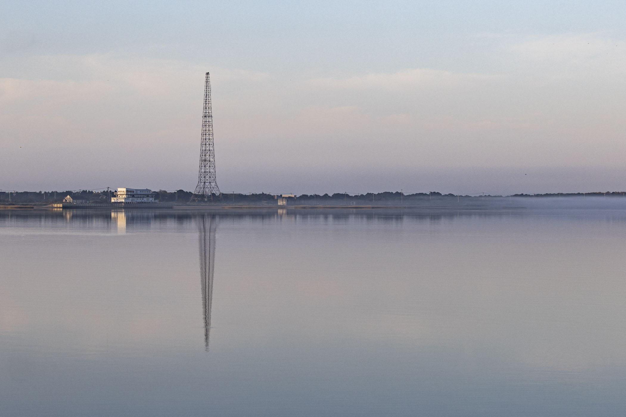 a radio tower across tranquil inland waters